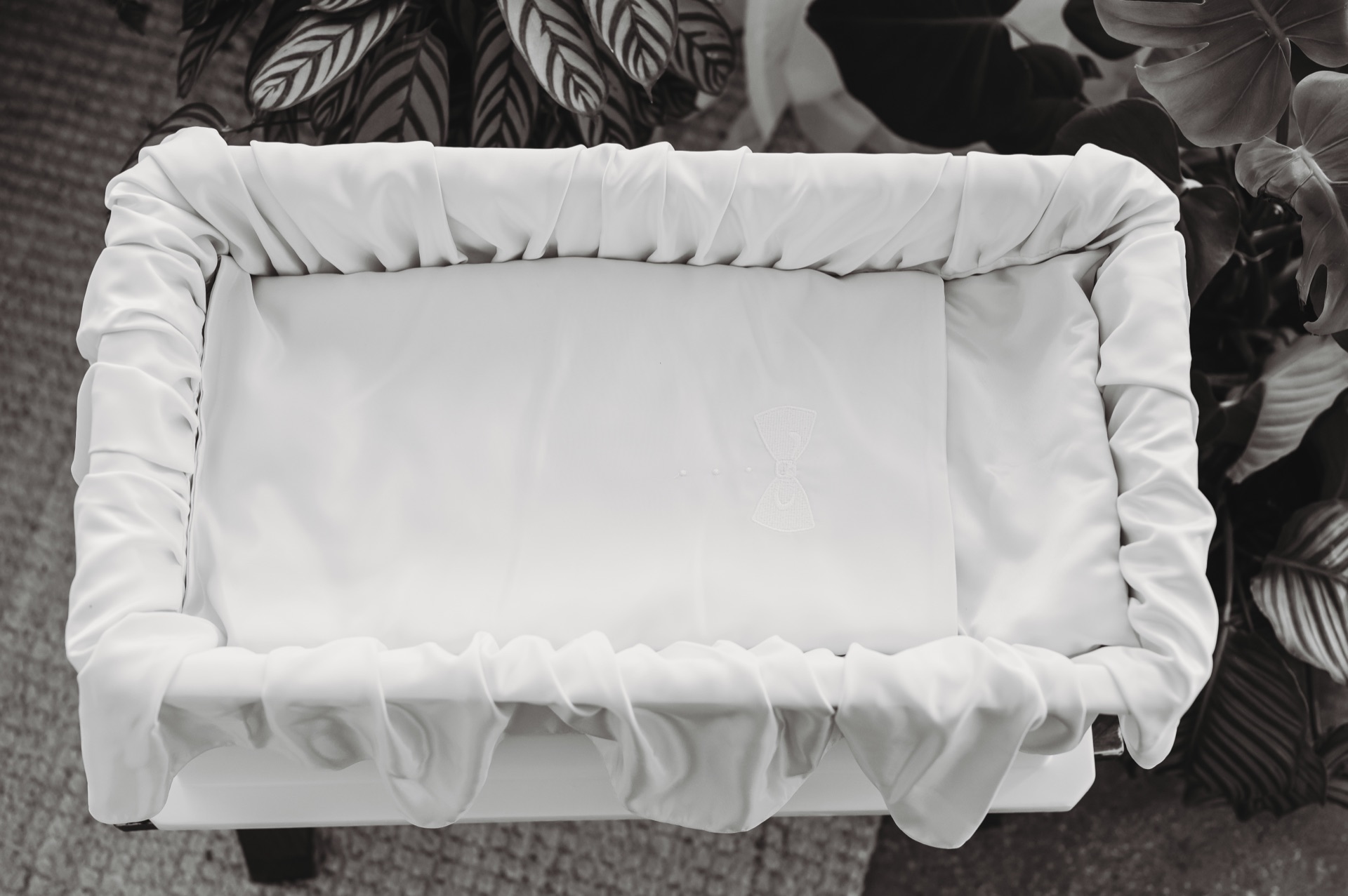 Cream-colored casket with white lace trim