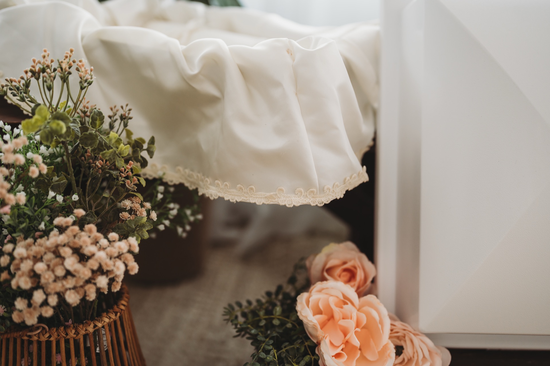 Beautiful white casket with wedding dress fabric and flowers