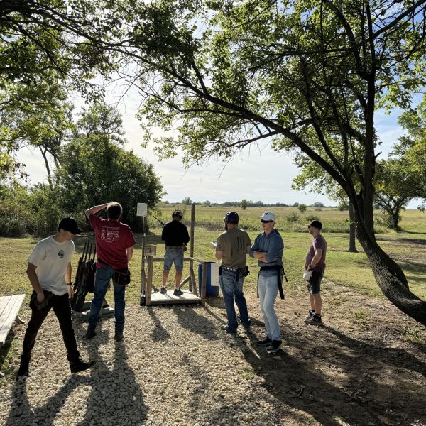 Group_of_men_preparing_clay_outdoors