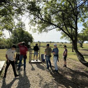 Group_of_men_preparing_clay_outdoors