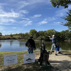 Two_men_clay_shooting_by_riverbank