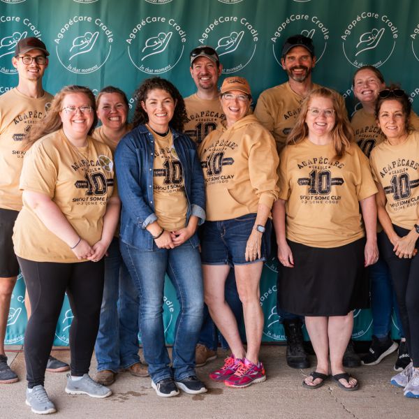 Agape_team_at_event_wearing_yellow_shirts_smiling