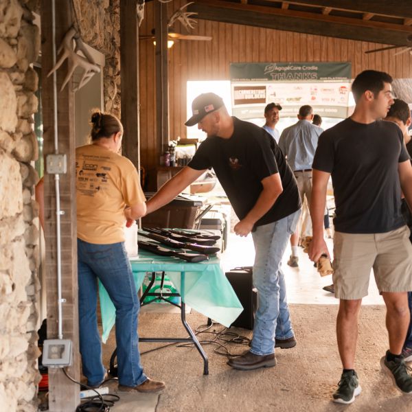 Crowd_at_outdoor_event_with_barbecue_grill_and_dining_table