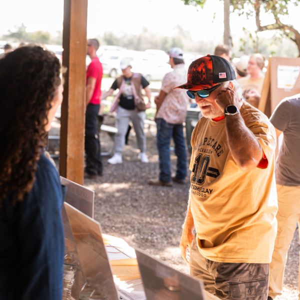 Large_outdoor_gathering_near_wooden_structure