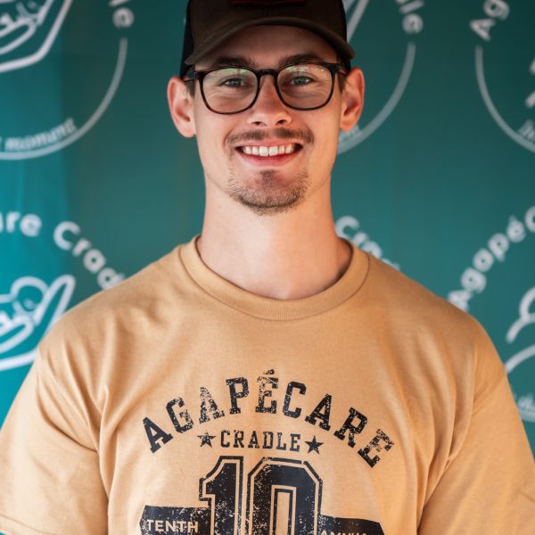 Man_in_casual_attire_posing_with_a_smile