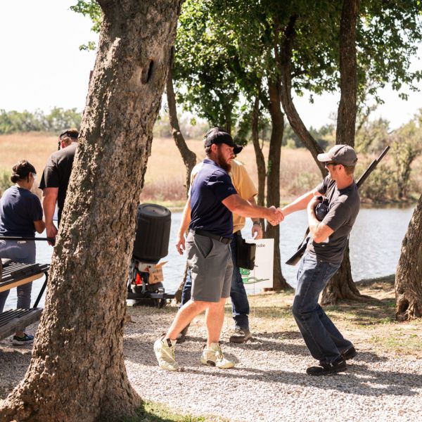 Man_shaking_hand_with_man_at_clay_shoot