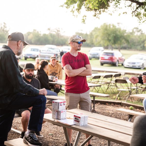 Men_having_conversation_at_outdoor_table
